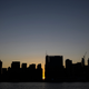 The sun sets behind 42nd Street in Manhattan during a power outage in New York City on July 13, 2019. A similar scene could play out on Wednesday as extreme heat strains the grid.